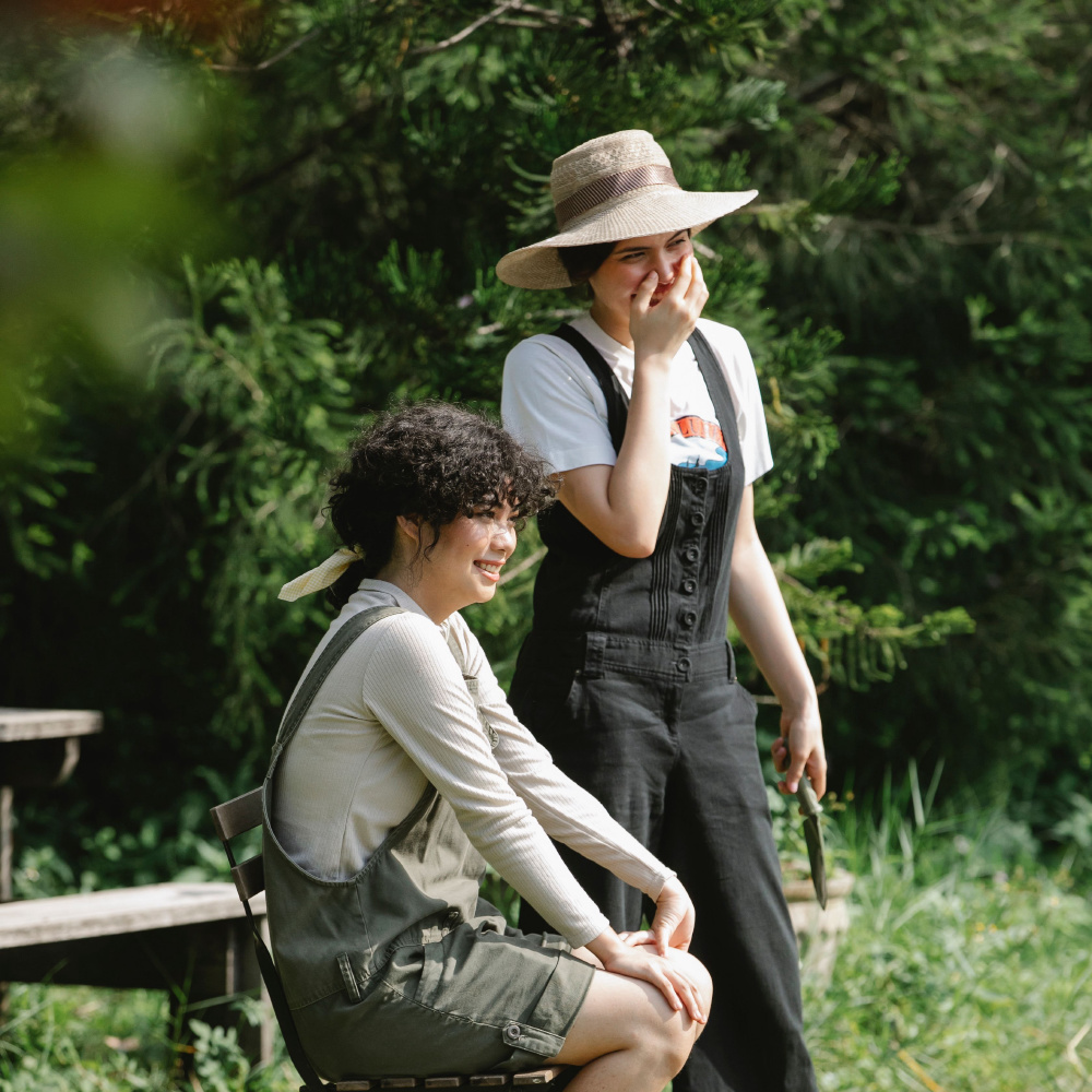Two friends laughing outdoors in the original color photograph