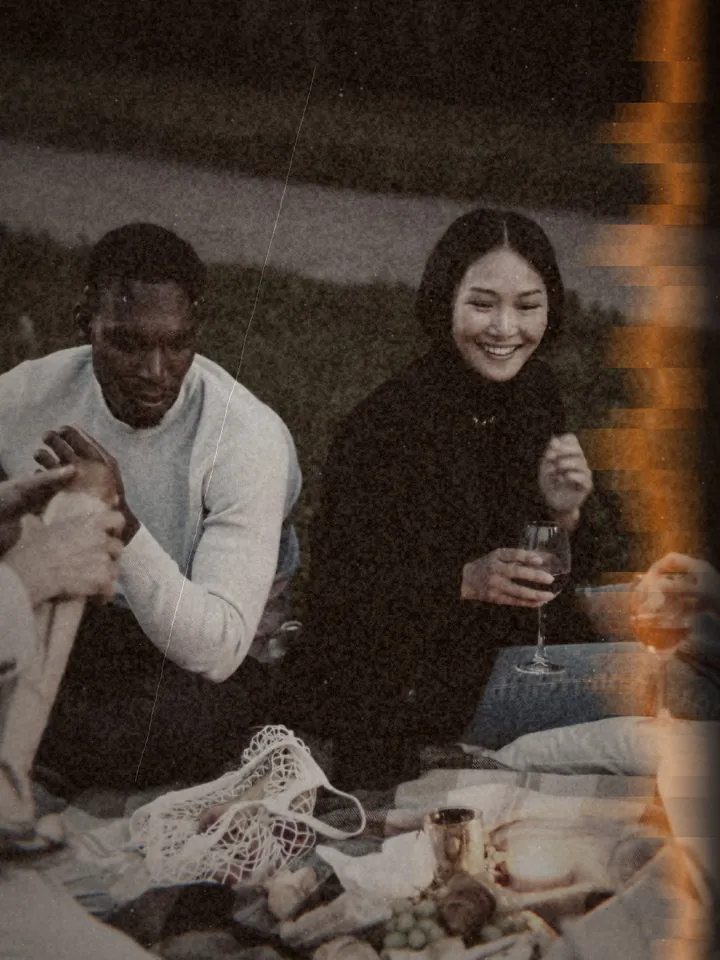 A couple sharing a drink on a picnic blanket at dusk — 1900 · Cardboard Pocket