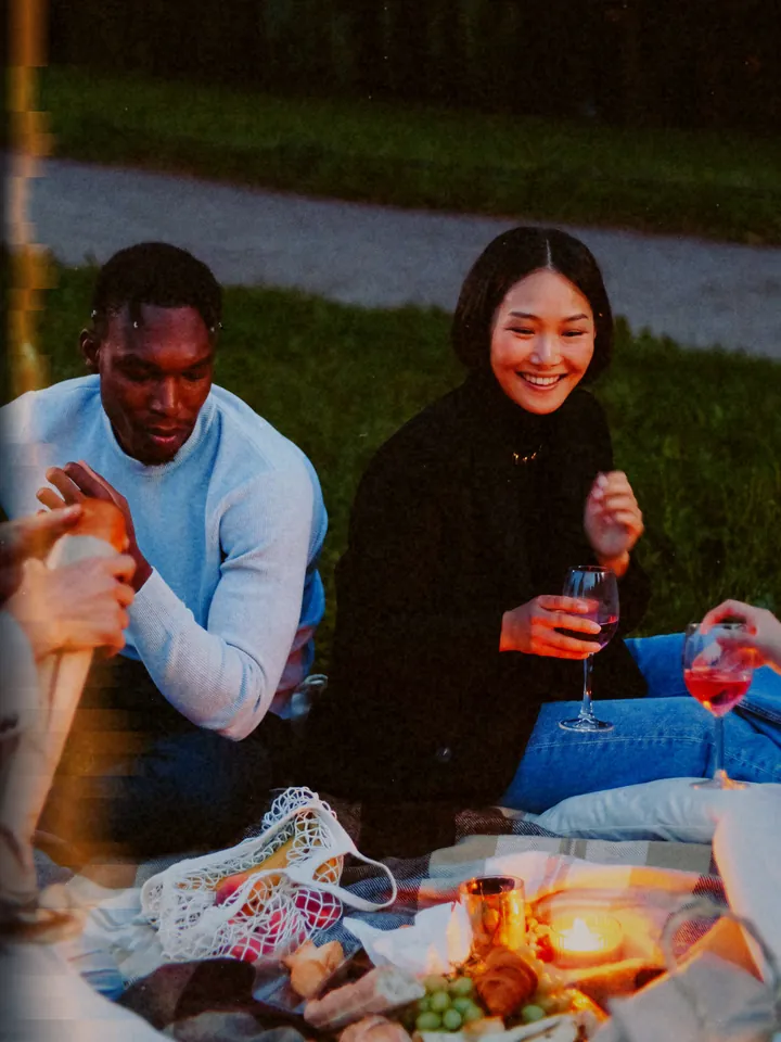 A couple sharing a drink on a picnic blanket at dusk — 1987 · 35 mm Compact
