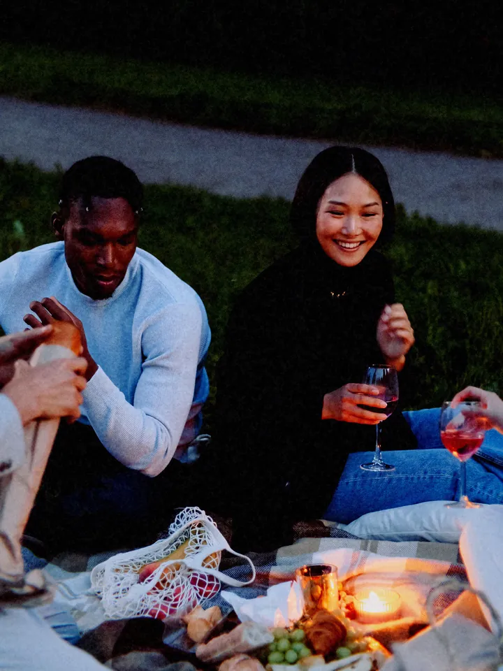 A couple sharing a drink on a picnic blanket at dusk — 1994 · Digital Beige