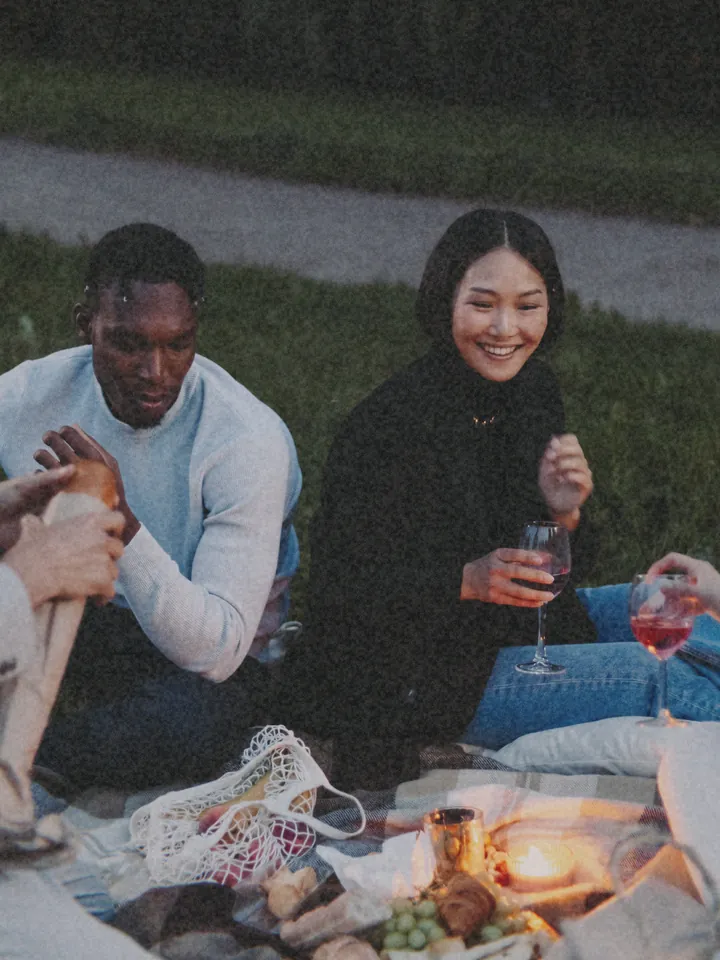A couple sharing a drink on a picnic blanket at dusk — 1995 · Home Video
