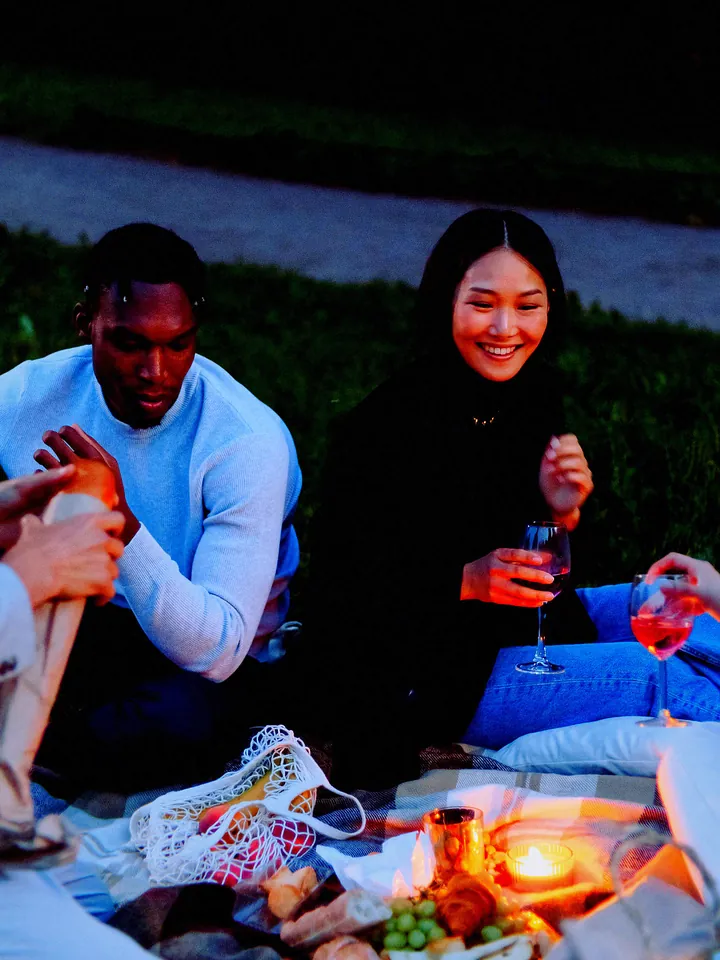 A couple sharing a drink on a picnic blanket at dusk — 2004 · CCD Digicam