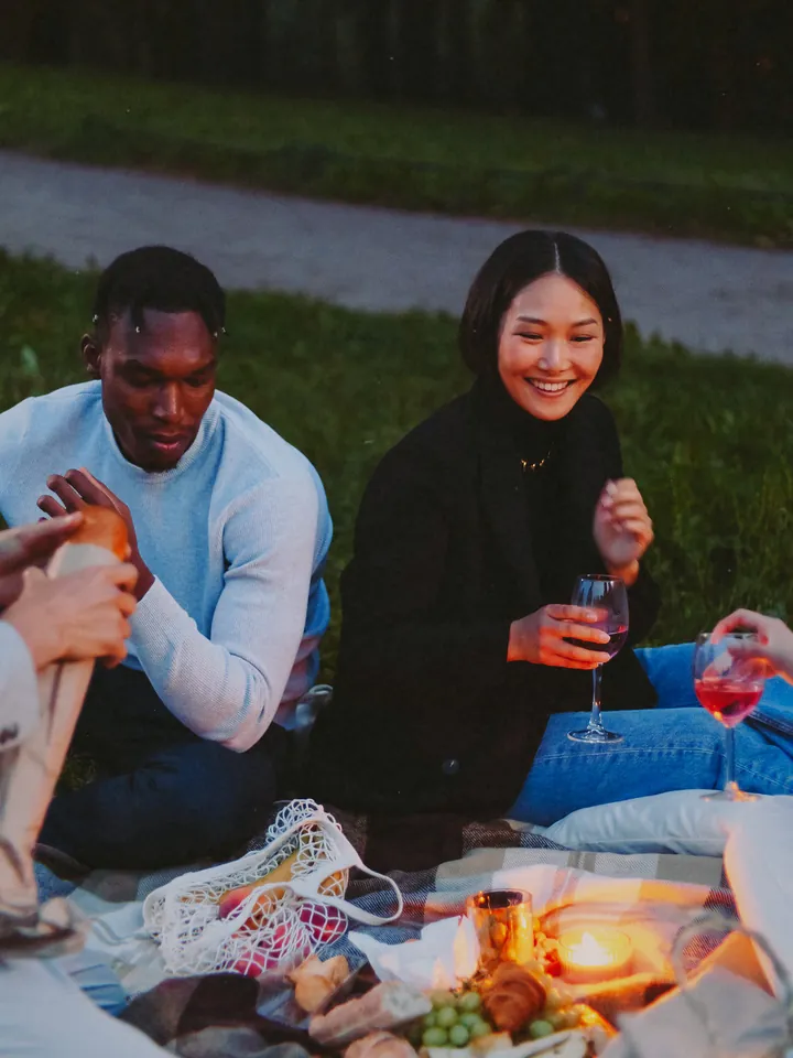 A couple sharing a drink on a picnic blanket at dusk — 2014 · Social Camera