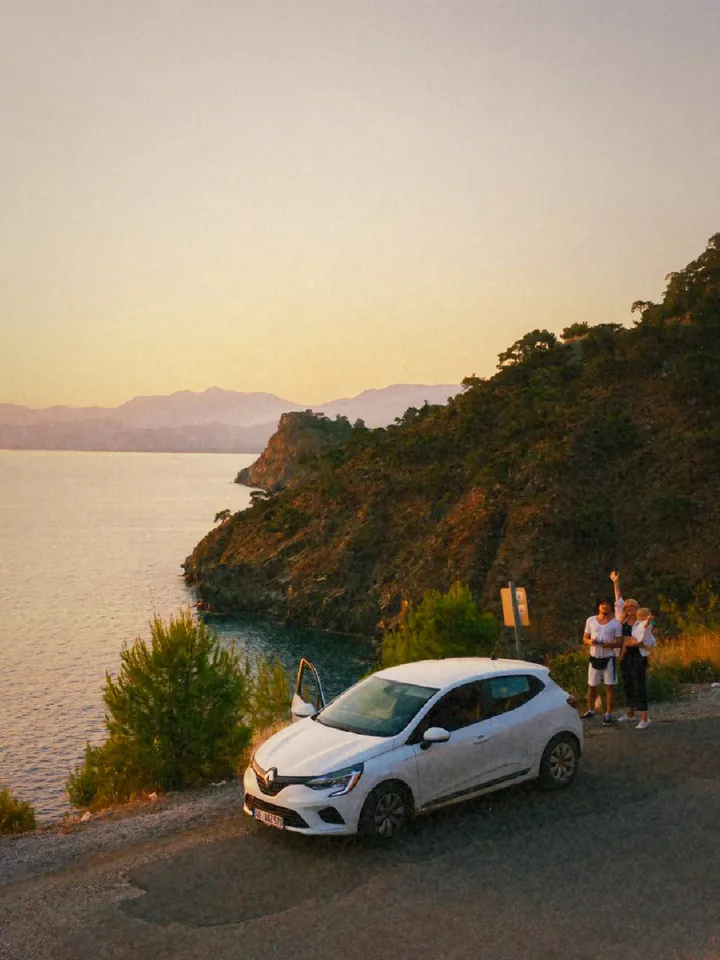 A white car on a coastal road at sunset — 1972 · Instant Fold