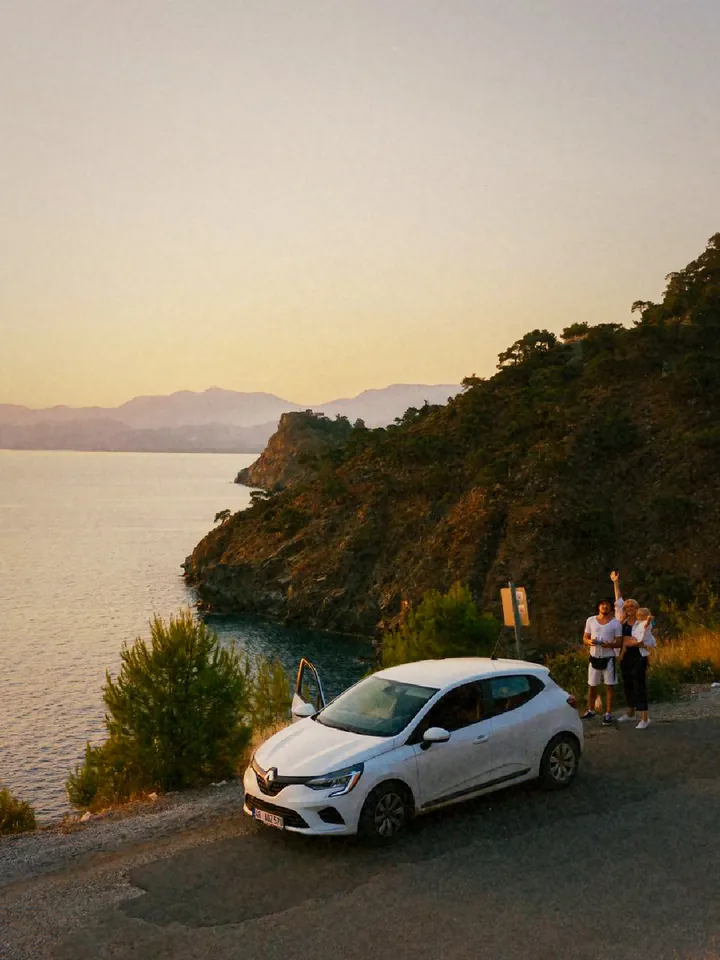 A white car on a coastal road at sunset — 1987 · 35 mm Compact